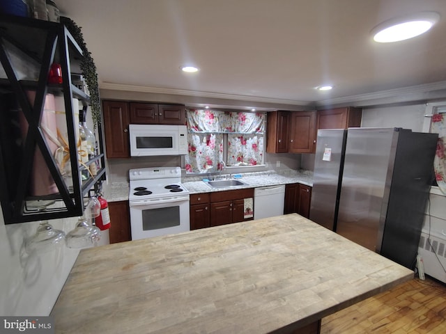 kitchen with sink, white appliances, dark brown cabinets, ornamental molding, and light wood-type flooring