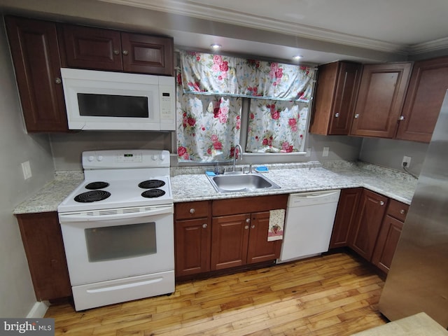 kitchen featuring sink, crown molding, white appliances, dark brown cabinetry, and light hardwood / wood-style floors