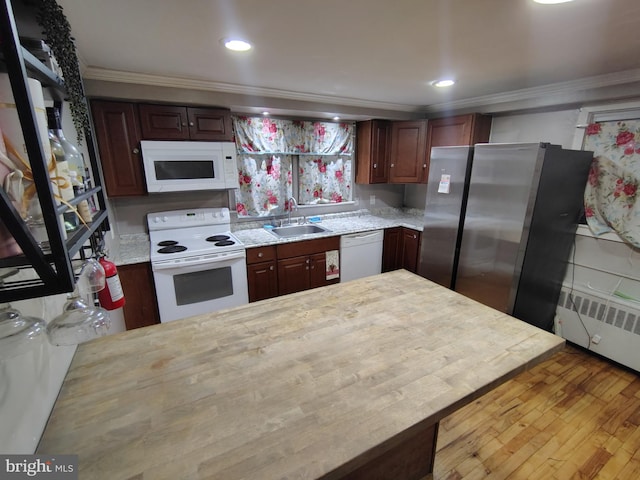 kitchen featuring sink, white appliances, light hardwood / wood-style flooring, radiator heating unit, and ornamental molding