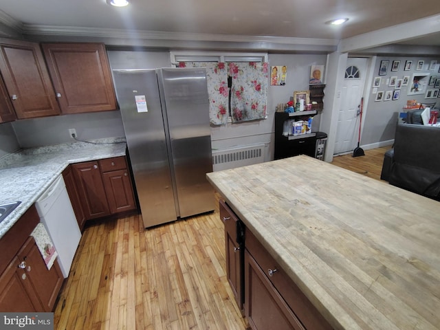 kitchen featuring white dishwasher, radiator, stainless steel fridge, and light wood-type flooring