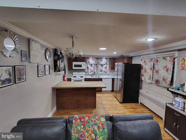 kitchen with crown molding, radiator heating unit, white appliances, and light hardwood / wood-style flooring