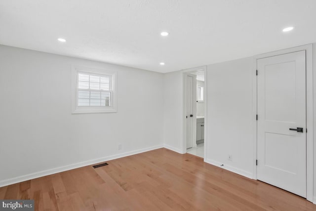 spare room with light hardwood / wood-style flooring