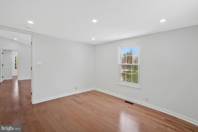 spare room with wood-type flooring