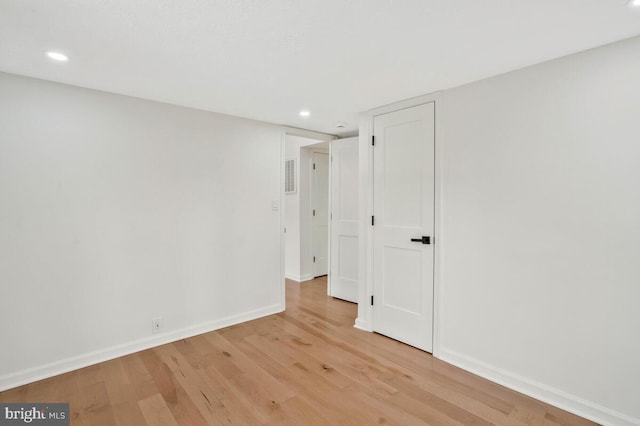 unfurnished room with light hardwood / wood-style flooring