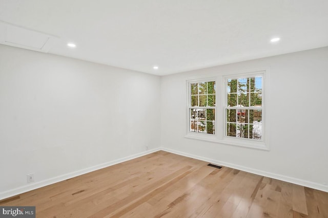 unfurnished room with light hardwood / wood-style floors