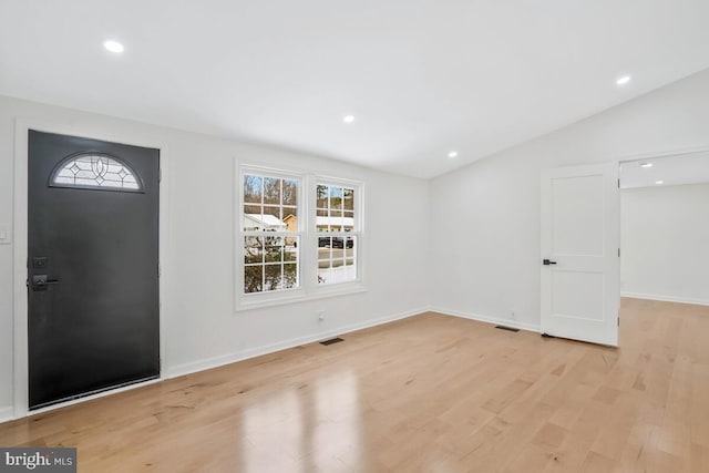 foyer featuring vaulted ceiling and light wood-type flooring