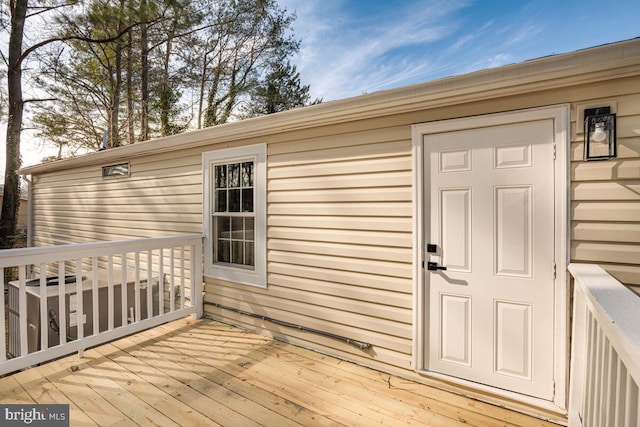 view of exterior entry with a wooden deck