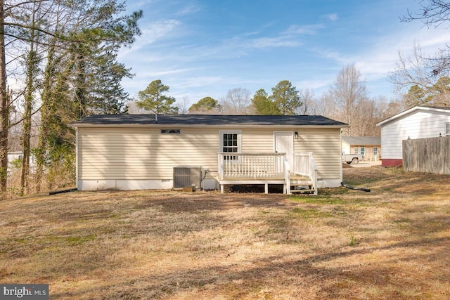 back of house featuring a wooden deck, a yard, and central air condition unit