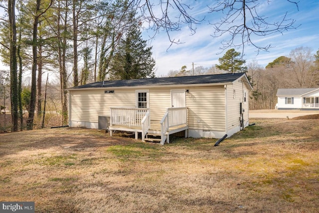 back of house with a yard and a deck