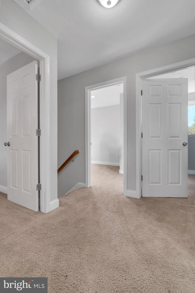 spare room featuring light colored carpet