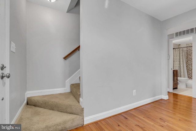 staircase with wood-type flooring