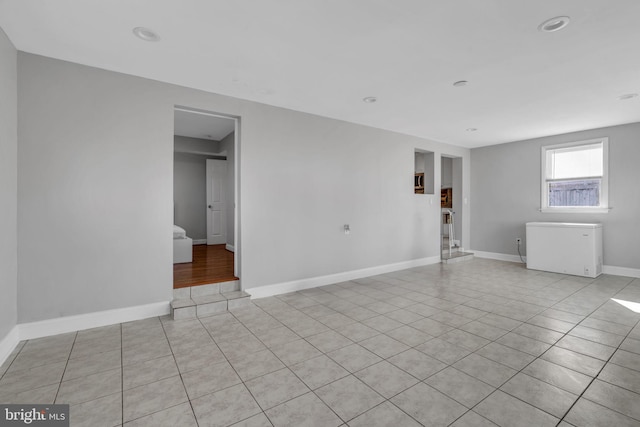 spare room featuring light tile patterned floors