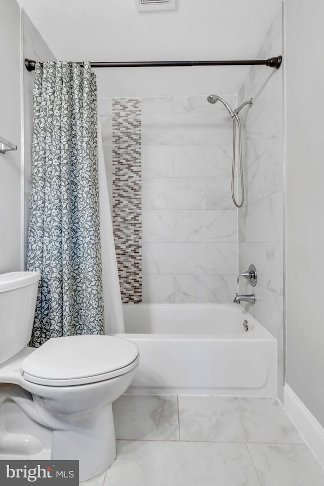 bathroom featuring shower / bath combination with curtain and toilet