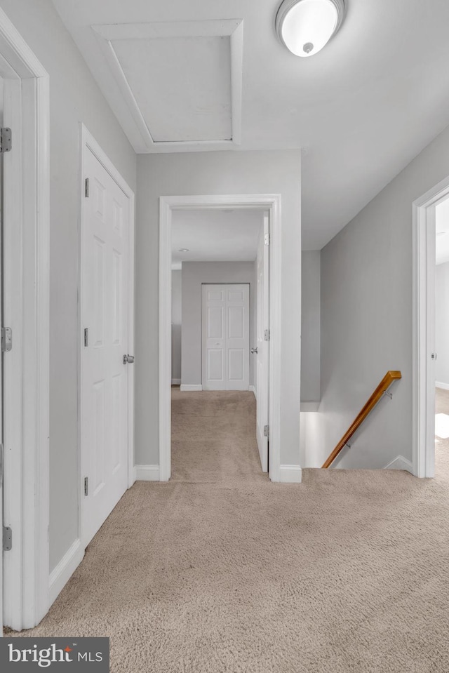 corridor featuring light colored carpet