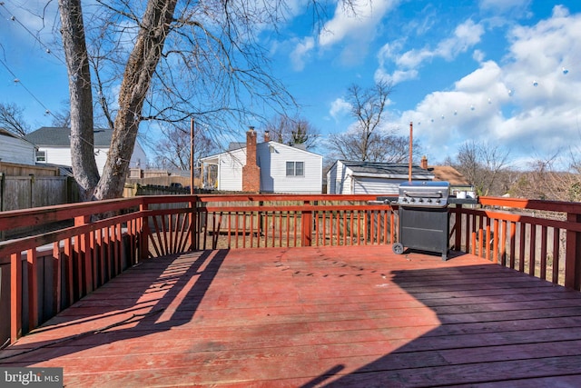 wooden deck featuring a grill