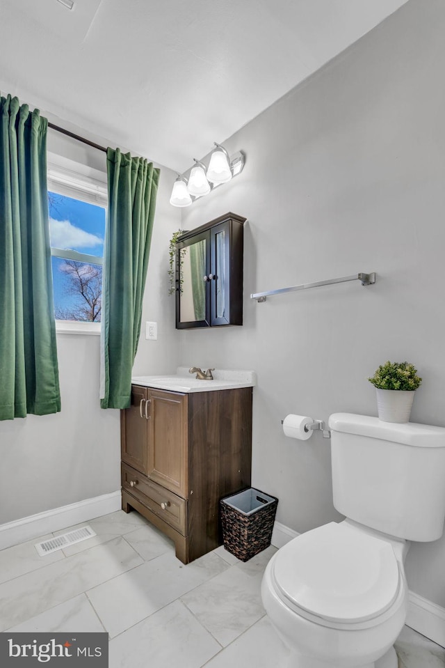 bathroom with vanity and toilet