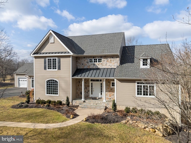 view of front of property with a garage and a front lawn