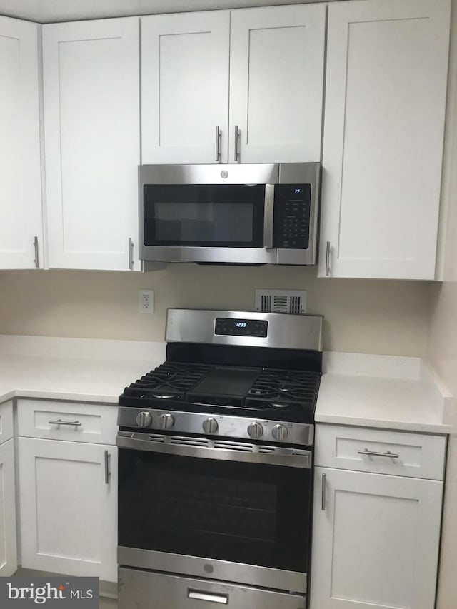 kitchen with appliances with stainless steel finishes and white cabinets