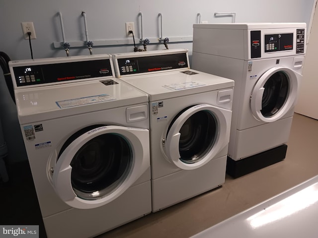 clothes washing area featuring washer and clothes dryer