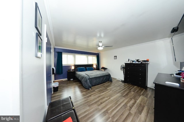 bedroom with dark hardwood / wood-style flooring, ornamental molding, and ceiling fan