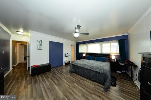 bedroom with dark hardwood / wood-style flooring, ceiling fan, and crown molding