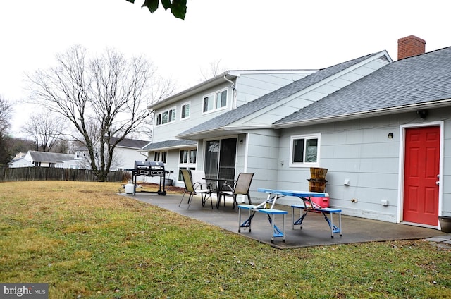 back of property featuring a patio and a lawn