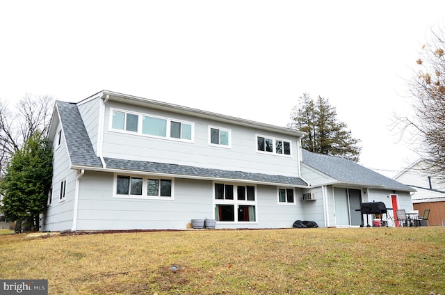 rear view of house featuring a yard