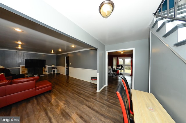 living room featuring ornamental molding and dark hardwood / wood-style floors