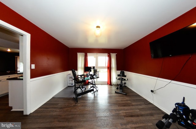 workout area with dark wood-type flooring