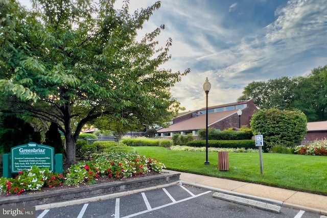 view of parking featuring a yard