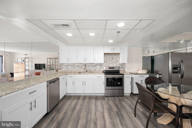 kitchen with white cabinetry, appliances with stainless steel finishes, sink, and tasteful backsplash