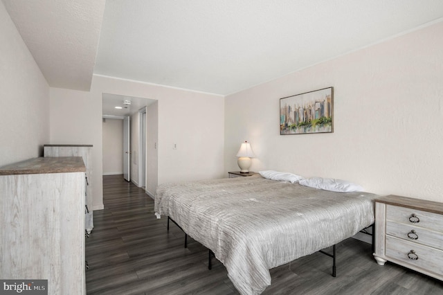 bedroom with dark hardwood / wood-style flooring