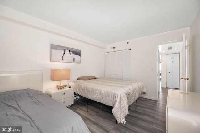 bedroom with a closet and dark hardwood / wood-style floors