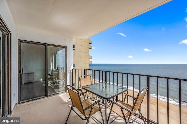 balcony with a water view and a beach view