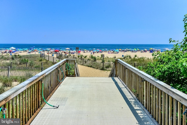 exterior space with a water view and a view of the beach