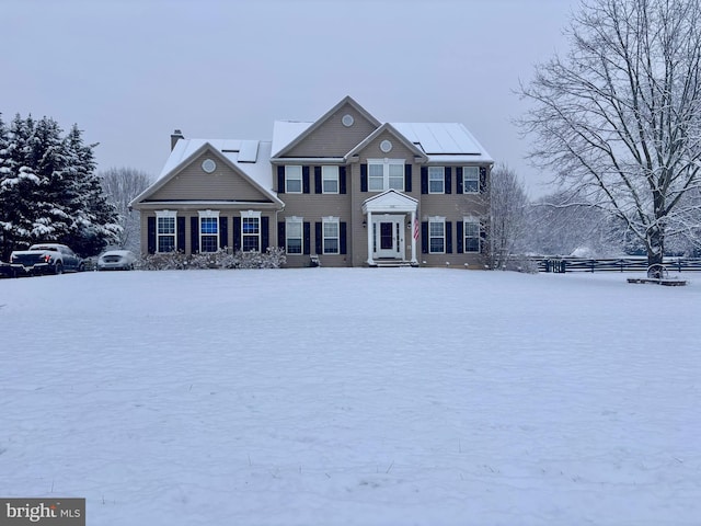 colonial-style house featuring a chimney