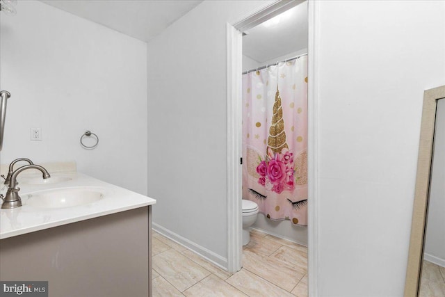 bathroom featuring double vanity, curtained shower, toilet, and a sink