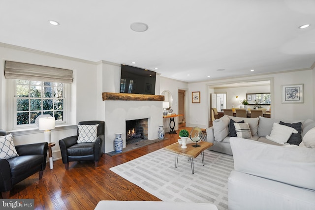 living room featuring dark hardwood / wood-style flooring and ornamental molding