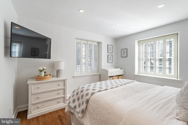 bedroom with dark hardwood / wood-style flooring