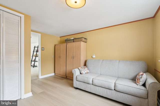 living room featuring ornamental molding and light hardwood / wood-style floors