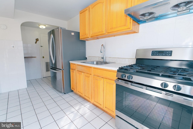 kitchen with light tile patterned flooring, ventilation hood, sink, stainless steel appliances, and light brown cabinets