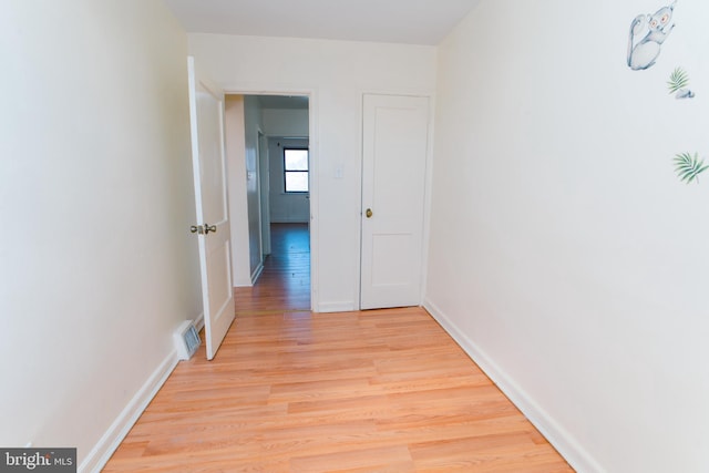 corridor with light hardwood / wood-style flooring