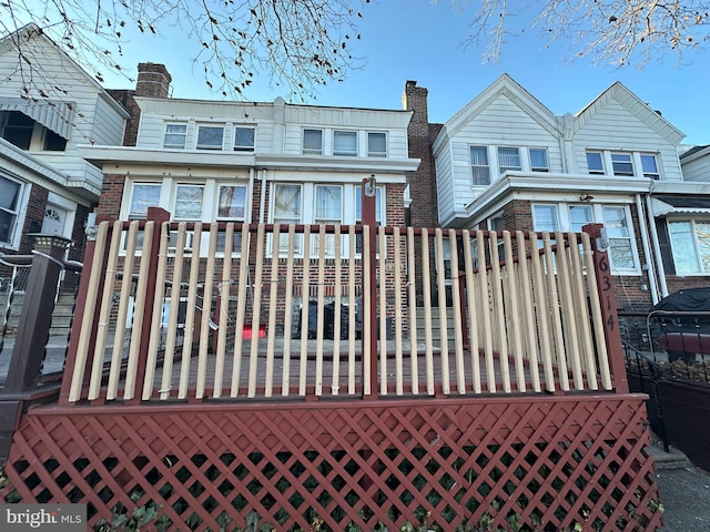 exterior space featuring brick siding and a chimney