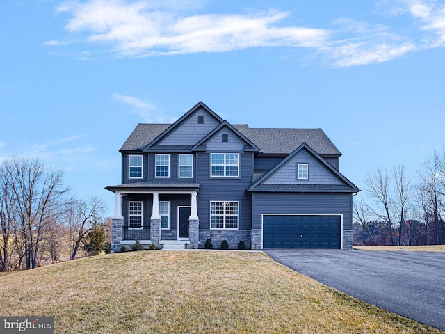 craftsman-style house with a porch, a garage, and a front yard