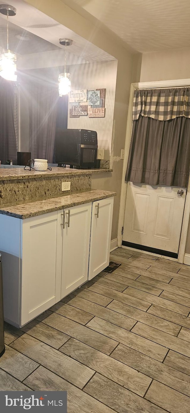 bathroom with wood-type flooring