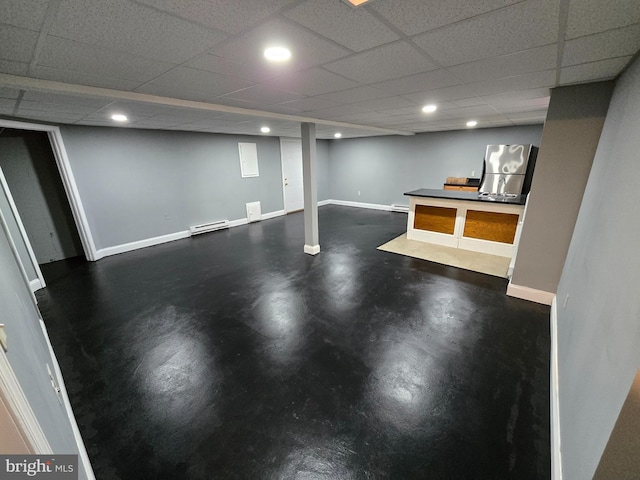 basement with a baseboard radiator and a paneled ceiling