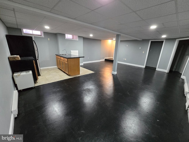 interior space with sink and a drop ceiling