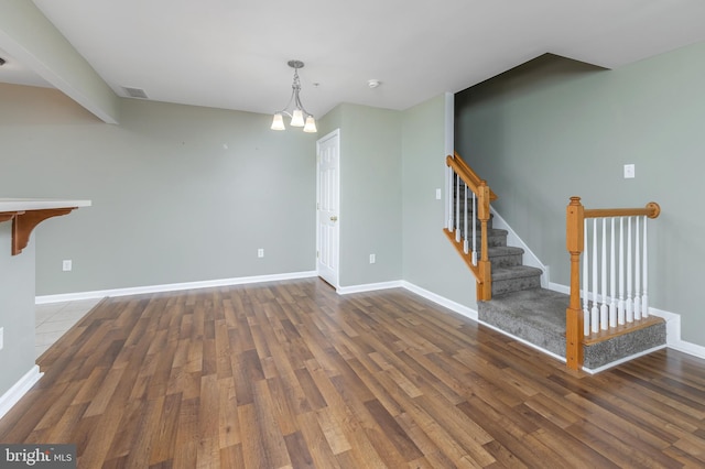 interior space with dark wood-type flooring and an inviting chandelier