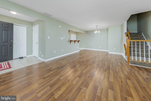 foyer featuring light hardwood / wood-style flooring and a notable chandelier