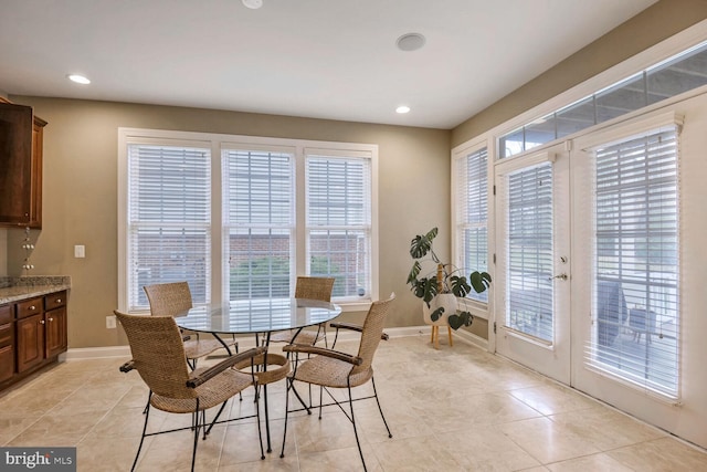 dining area featuring light tile patterned floors and french doors